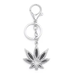 Maple leaf keychain pendant featuring sparkling rhinestones and black enamel detail