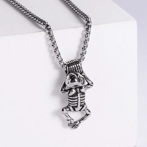 Macro shot of silver stainless steel meditation skeleton pendant with thick chain links