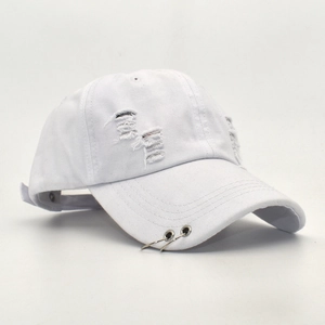 Detail of white distressed cotton baseball cap featuring metal rings and frayed hole effects