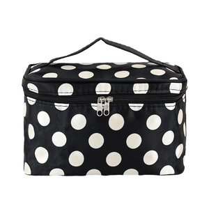 Portable black cosmetic bag with white polka dots featuring top handle and dual zippers