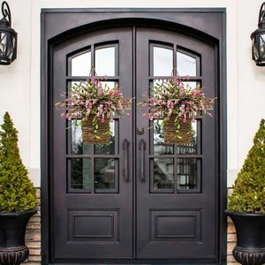 Detailed view of artificial pink wildflower door baskets on a dark symmetrical entrance