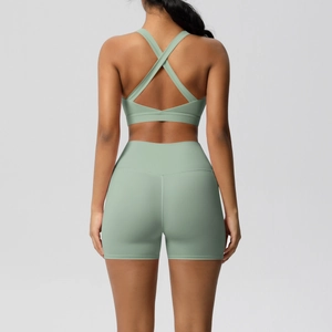 Detail of cross-back yoga bra and high-waist shorts in mint green athletic set