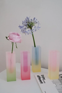Close-up of four frosted gradient acrylic vases in geometric rectangular shapes