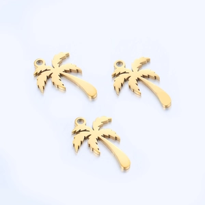 Macro view of three gold mirror-polished stainless steel palm tree pendants for DIY jewelry