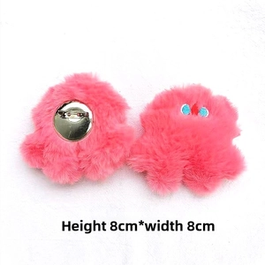 Front and back detail of 8cm pink plush monster brooch with embroidery and pin clasp
