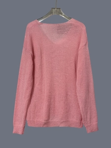 Detail of soft pink V-neck knit sweater with high-quality texture hanging on a hanger