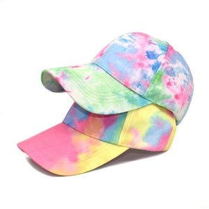 Detail of colorful tie-dye baseball caps with cotton twill texture and curved brim