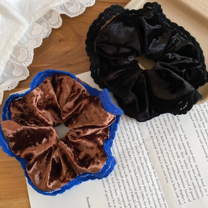 Close-up of velvet lace hair scrunchies in black and brown with vintage crochet edges