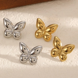 Elegant 18k gold and silver butterfly earrings with a polished mirror finish on stone