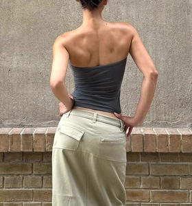 Rear view of seamless dark grey tube top and khaki cargo maxi skirt on a model