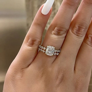 Close-up of gold square-cut diamond ring paired with a sparkling pavé eternity band