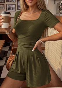 Detail view of olive green ribbed knit short sleeve top and matching shorts on a model