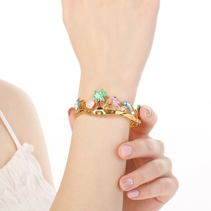 Golden stainless steel ocean theme bracelet with enamel palm tree and dolphin charms
