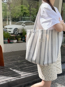 Large striped canvas tote bag for women featuring a minimalist black and white pattern
