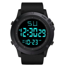 Macro shot of large digital sports watch with teal EL backlight and textured strap