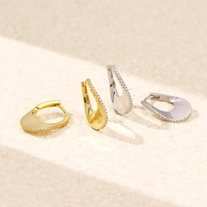 Detail showing S925 sterling silver U-shaped earrings with gold plating and zircons