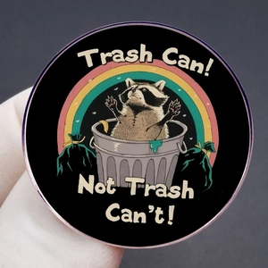 Funny raccoon enamel pin featuring Trash Can Not Trash Can't quote with rainbow detail