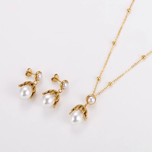 Detail of gold octopus pearl necklace and matching stud earrings set for women