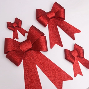 Set of four red glitter Christmas bows in various sizes for holiday and party decorations