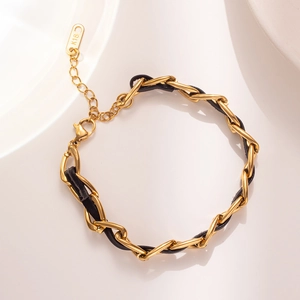 Chic gold-tone titanium steel chain bracelet with black leather weaving and K18 charm