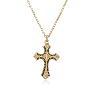 Macro shot of 18K gold plated cross pendant featuring black and clear zircon stones
