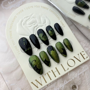 Handmade stiletto press-on nails featuring green cat eye effect and black cat silhouettes