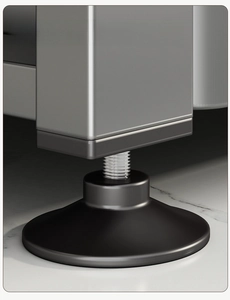 Close-up of adjustable furniture leg with square metal support and round non-slip base