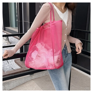 Detail view of pink mesh tote bag showing large hole texture and interior capacity