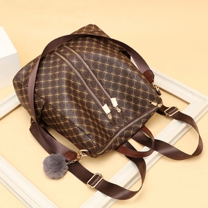 Classic monogram brown leather backpack for women with gold zippers and grey plush pendant