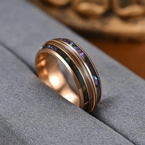 Rose gold stainless steel ring with guitar string texture and colorful shell inlay
