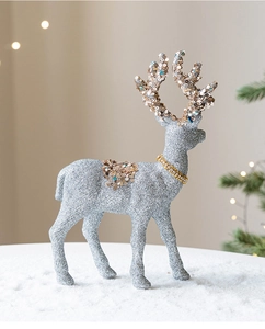 Detailed close-up of silver Christmas reindeer ornament with festive champagne glitter