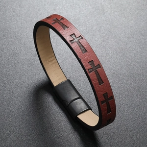 Close-up of brown leather multilayer bracelet with cross embossing and black magnetic clasp