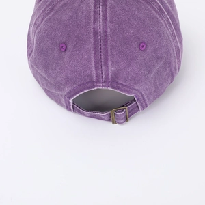 Detail view of purple washed baseball cap back with adjustable bronze metal buckle