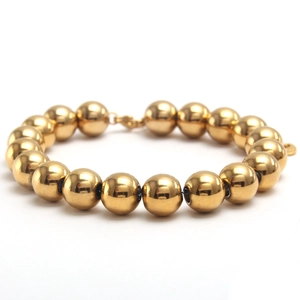Detail of 10mm polished gold stainless steel beads and lobster clasp on jewelry bracelet