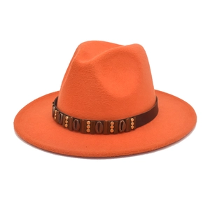 Detailed view of bright orange wool fedora featuring a vintage ethnic leather hatband