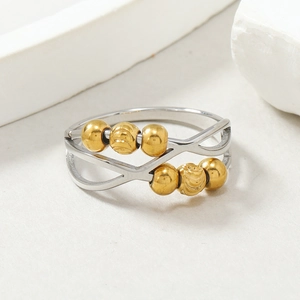 Stress relief rotating stainless steel ring with 6 golden beads and hollow out design