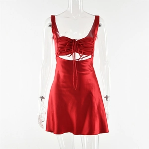 Detail of red satin dress featuring a sweetheart neckline, ruched bust, and waist cutout
