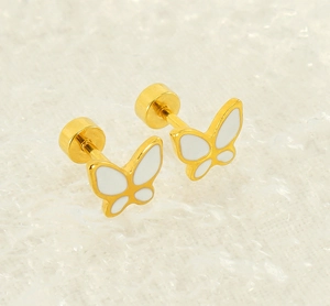 Detailed close-up of golden butterfly studs with white enamel wings and secure backs