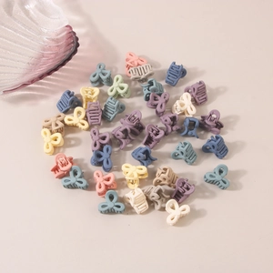 Detail shot of mini frosted bow hair clips in assorted macaron pastel colors