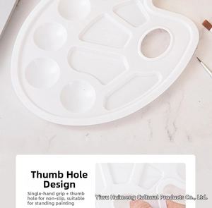Close-up of white plastic palette with thumb hole design for stable artistic painting