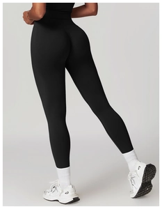 Rear view of black high-waisted yoga pants showing lifting effect and peach hip tailoring