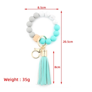 Silicone and beech wood bead keychain bracelet with mint green tassel and dimensions