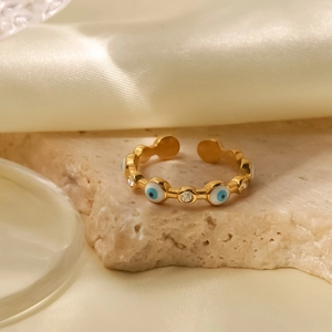 Close-up of 18K gold-plated evil eye ring with blue enamel and sparkling zircons