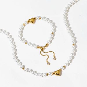 Polished gold heart charm pearl necklace and bracelet set with adjustable drawstring