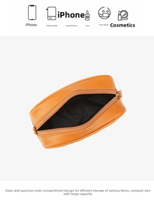 Internal view showing large capacity and black fabric lining of the orange quilted camera bag