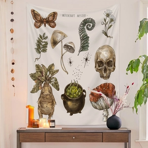 Detail of bohemian witchcraft mystery tapestry with skull, moth, and vintage botanical patterns