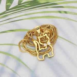 Detail of 18k gold plated cat pendant necklace with sparkling cubic zirconia eyes