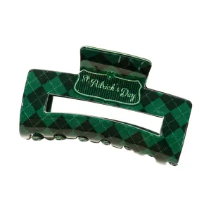 Green checkerboard square hair claw clip with St. Patrick's Day text on white background