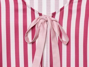 Close-up of pink and white striped fabric with a light pink ribbon bow on the neckline