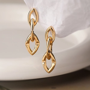 Minimalist gold-plated irregular geometric hoop earrings with modern metallic texture